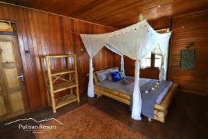 RinondoranPulisan Resort的一间卧室配有一张带蚊帐的床