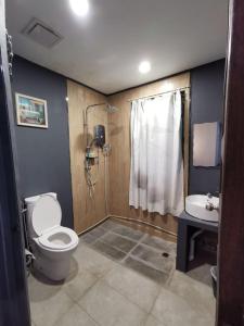 仙本那安利假日旅馆的浴室配有卫生间、淋浴和盥洗盆。