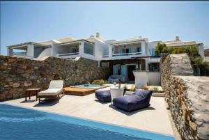 帕诺尔莫斯米科诺斯Villa ANASA private Pool & Jacuzzi 8pax at Panormos的一座房子,旁边设有游泳池