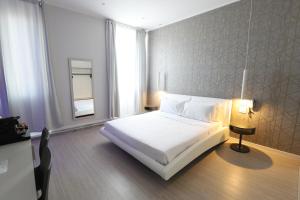 米兰Cadorna Luxury Hotel的卧室配有白色的床和窗户。