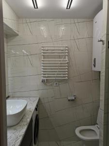 巴统Orbi beach tower的白色的浴室设有水槽和卫生间。