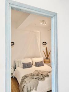 苏卡雷斯埃勒尼亚别墅酒店的卧室配有白色的床和镜子