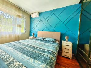 波德戈里察Luxury apartment Podgorica的一间卧室设有蓝色墙和一张床