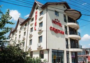 Afumaţi克里斯蒂安酒店的一座白色的大建筑,上面有标志