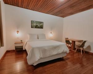 坎波斯杜若尔当Casa Wald的卧室配有一张白色的大床和一张桌子