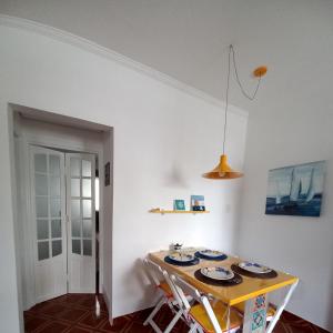 大普拉亚Solar Canto do Forte的一间用餐室,配有一张桌子和盘子