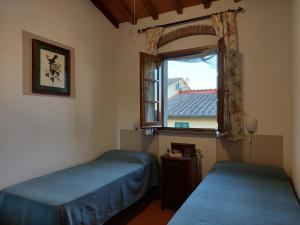 Pian dei CerriCASA PARTINGOLI的一间卧室设有两张床和窗户。
