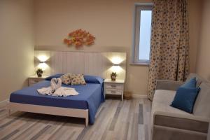 贾迪尼-纳克索斯B&B Marina Blu的一间卧室配有蓝色的床和沙发