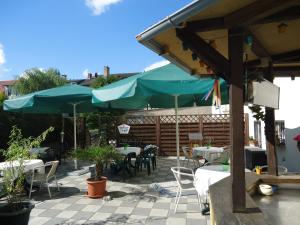 马尔欣马库斯酒店及餐厅的一个带桌椅和遮阳伞的庭院