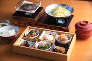 由布市Yufudake Ichibo no Yado Kirara的一张木制午餐盒,桌上放着各种美食