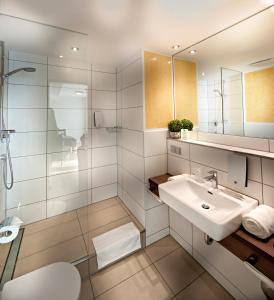 曼海姆曼海姆家庭旅馆的白色的浴室设有水槽和镜子