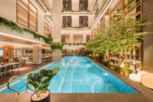 雅加达Ashley Tanah Abang的植物建筑中的室内游泳池