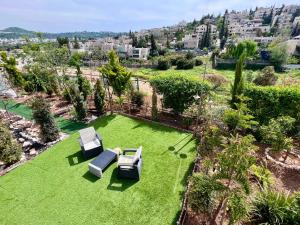 Abū Ghaushמבט אל הואדי的享有草坪的空中景致,配有两把椅子和一张桌子