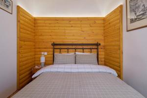 莫诺登德里Archontiko Rapti Stone Traditional House的一间卧室配有一张木墙床