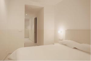 塔拉桑纳阿拉贡HOTEL LA FONDA B&B的白色卧室配有床和镜子