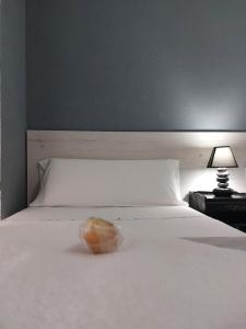 洛格罗尼奥圣马修酒店的坐在白色床边的甜甜圈