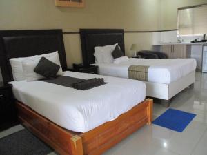 弗朗西斯敦River View Villa Self Catering的配有白色床单的酒店客房内的两张床