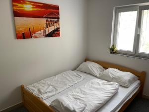 比托福Chata Marine的卧室内的一张床铺,墙上挂着一幅画