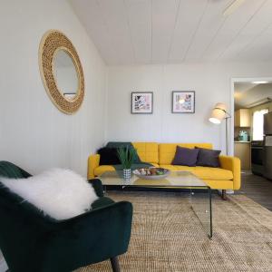 DwightMuskoka Waterfront Retreat的客厅配有黄色的沙发和桌子
