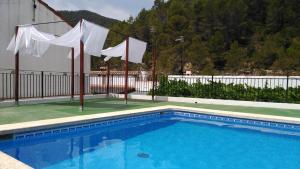 Alcudia de VeoCasa Rural de Benitandús的一座带白色旗帜的游泳池和一座建筑