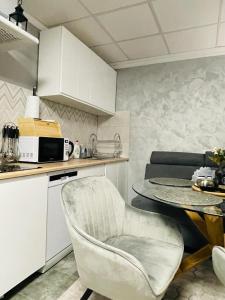 斯托尼拉斯奇Domek Zielone Centrum的厨房配有桌子、椅子和微波炉
