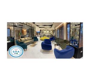 曼谷The Neuf@Ratchada的一个带蓝色椅子和沙发的图书馆