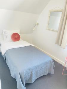 腓特烈港aday - Frederikshavn City Center - Single room的一间卧室配有一张红色枕头的床