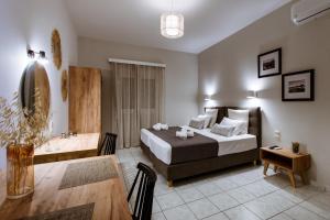 卡莱维斯Koulouris Apartments & Studios的酒店客房 - 带一张床和用餐室