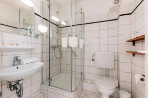 蒂门多弗施特兰德高尔施福克酒店的浴室配有卫生间、盥洗盆和淋浴。