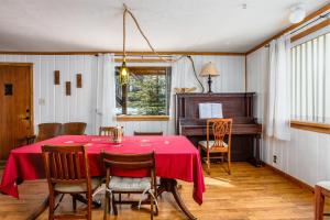 安克雷奇Northwood Cabin的一间带桌子和钢琴的用餐室