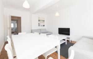 里斯本HOUZE_6 suite flat in Campolide near Parque Eduardo VII (Marquês Pombal)的白色的客厅配有白色家具和电视