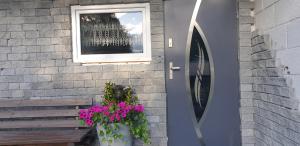 达伦Studio 5的一座带窗户、长凳和鲜花的建筑