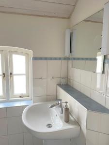 博恩Pension Walfischhaus的白色的浴室设有水槽和镜子