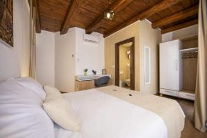 乌马格Hotel Natura Vilanija的一间带白色床的卧室和一间浴室