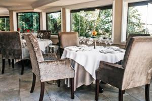 阿曼济姆托蒂精品景观水疗度假酒店的用餐室设有桌椅和窗户。