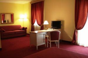 阿尼奥内伊尔都卡德尔桑尼奥酒店的酒店客房配有一张书桌、一台电视和一张沙发