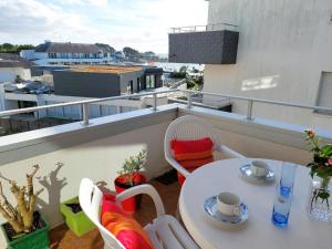 贝诺代Studio with partial sea views in the popular seaside resort of Benodet的阳台上配有白色的桌椅