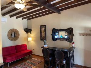 瓜达鲁佩镇Estancita Elena的客厅配有红色的沙发和镜子