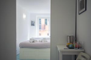 里奥马哲雷维亚德班奇旅馆的一间卧室配有一张床和一张桌子及窗户