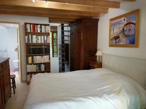 拉波勒Petite maison proche de la mer的一间卧室配有床和书架
