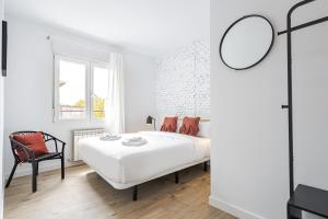 马德里Vallecano Apartments by Olala Homes的白色卧室配有床和椅子