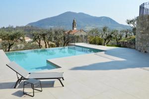 阿尔库阿佩特拉尔卡Borgo Petrarca的一个带长凳和椅子的游泳池