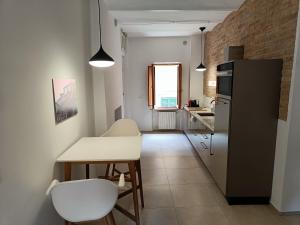 佩鲁贾I Capricci di Florian的一间带桌子和冰箱的小厨房