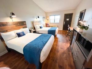 Saint ClairPINEMARK Inn Suites Events的酒店客房设有两张床和一台平面电视。