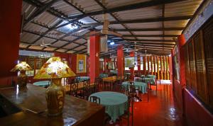 WasgamuwaS and K Safari Village Hotel - Wasgamuwa的餐厅设有桌椅和台灯