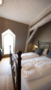 特里尔Boutiquehotel Kloster Pfalzel的一间卧室设有一张大床和一个大窗户