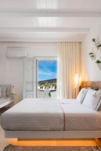 法罗斯岛Elements Sifnos Boutique的一间带大床的卧室和一个阳台