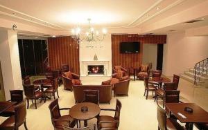 卡托劳塔翁雅典娜酒店的客厅配有桌椅和壁炉