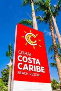 璜多里奥Coral Costa Caribe Beach Resort - All Inclusive的珊瑚海岸卡里比亚海滩度假村的标志