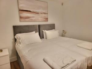 伦敦London City Modern Apartment, Woolwich的一张带两个枕头的大白色床